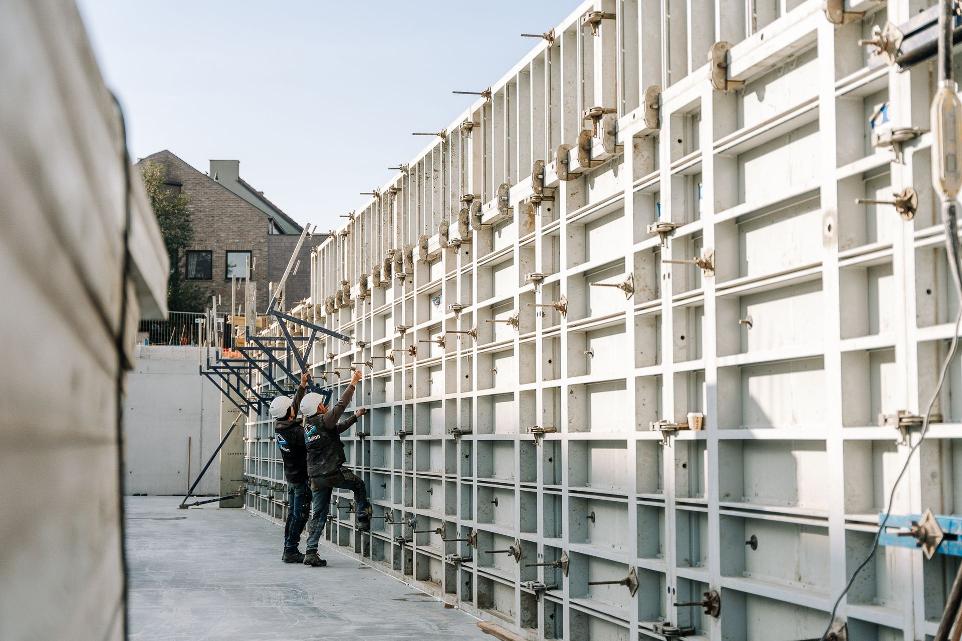 workers prepare formwork for concrete